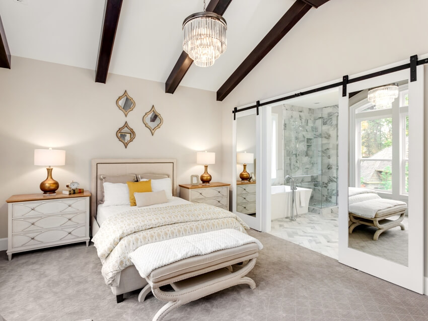 Beautiful bedroom with ensuite bathroom with wood beams 