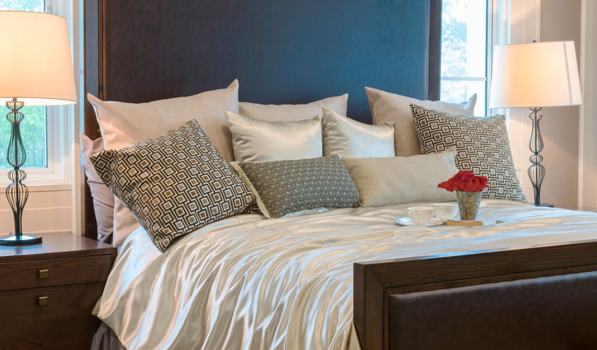 Bedroom with silk sheet pillows headboard lamp
