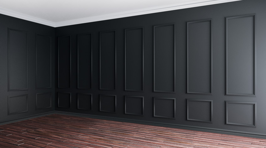 Black wall baseboard dark wood floor