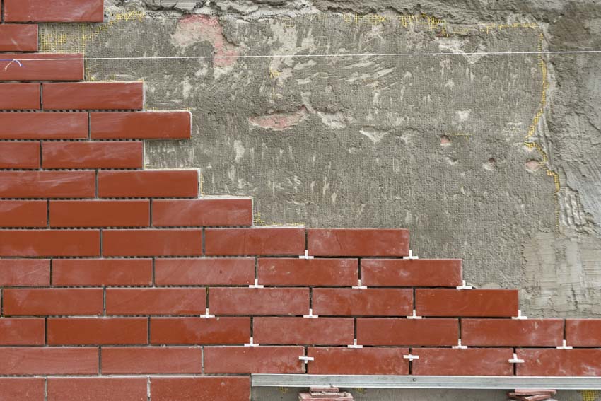 Brick masonry veneer on concrete foundation
