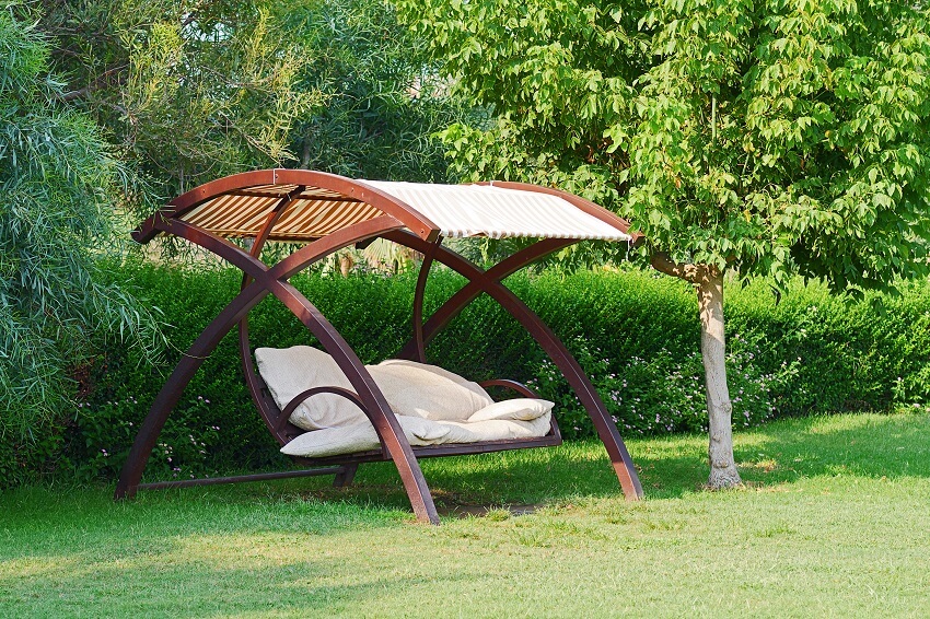 Canopy swing with cushions in garden 