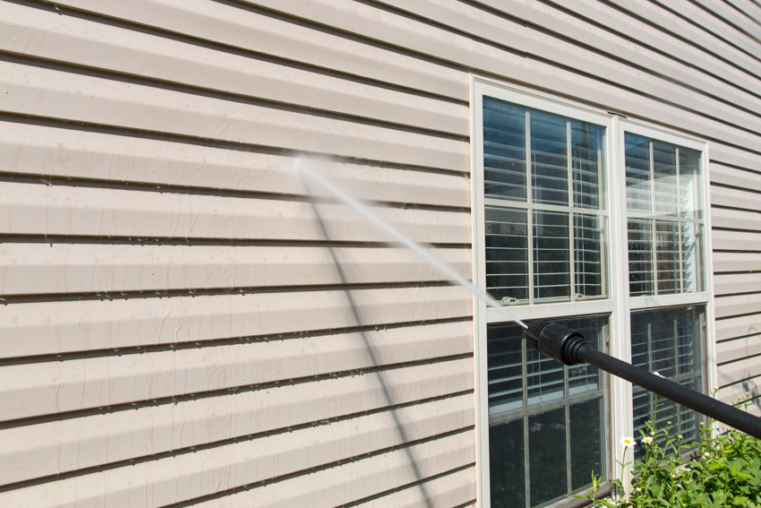 Cleaning the siding with a power sprayer