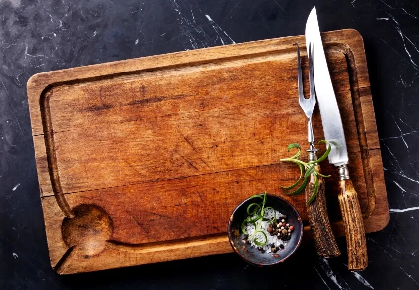 board seasonings and rosemary with fork and knife carving set