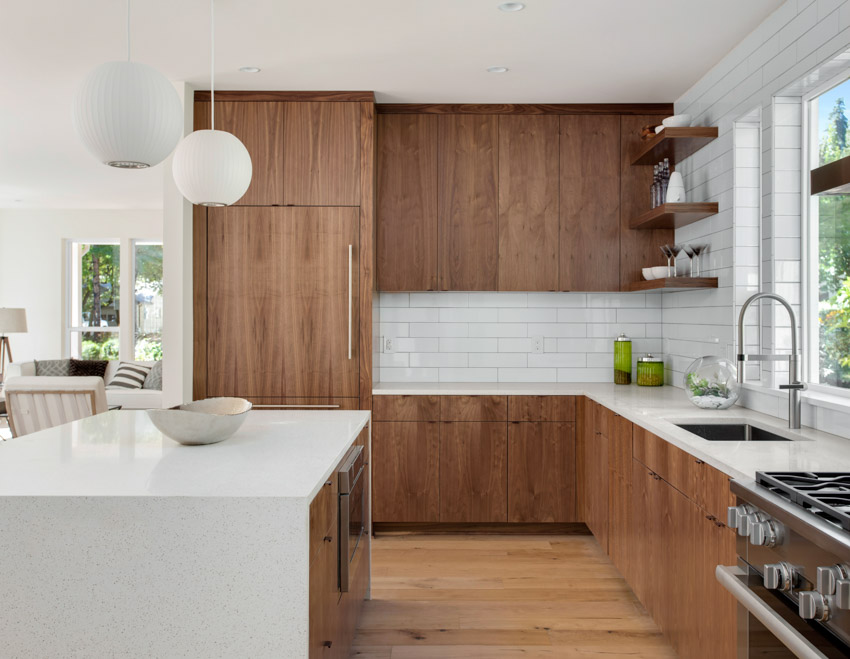 Floors and brown kitchen cabinets made of wood countertop windows faucet center island hanging light