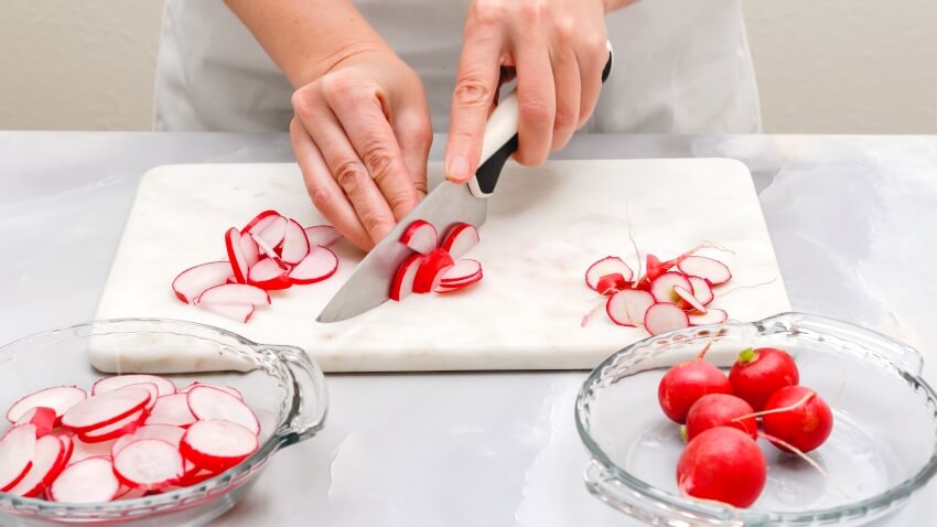Fresh sliced radish on marble cutting board