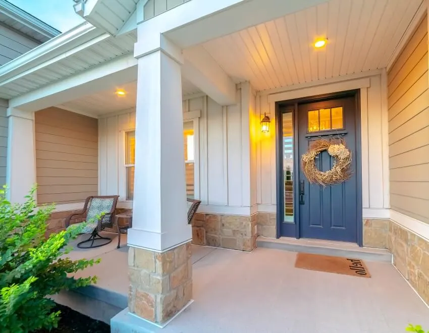 Front and sidelight of home with front porch and wood siding exetrior wall