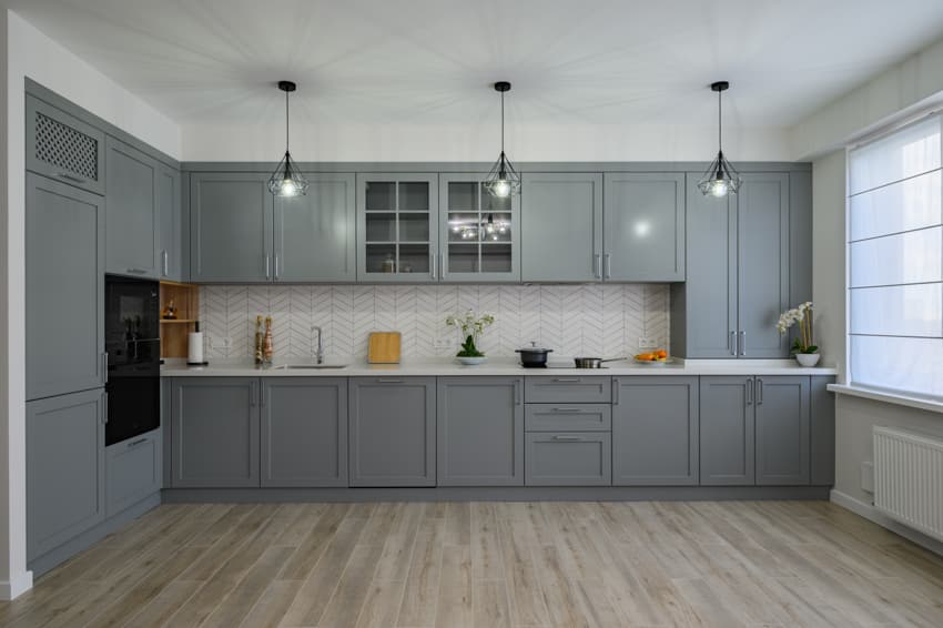 Gray cabinets with thermofoil wood floors and hanging lights
