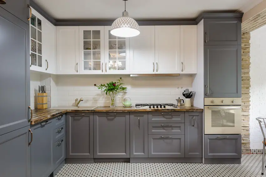 Gray kitchen cabinets, hanging light and chef's block counters