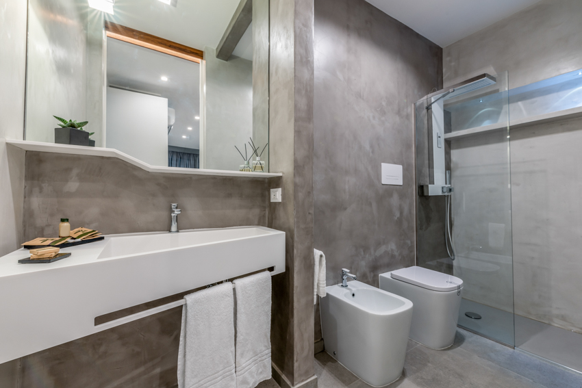 Gray tadelakt plaster finish bathroom shower mirror sink toilet
