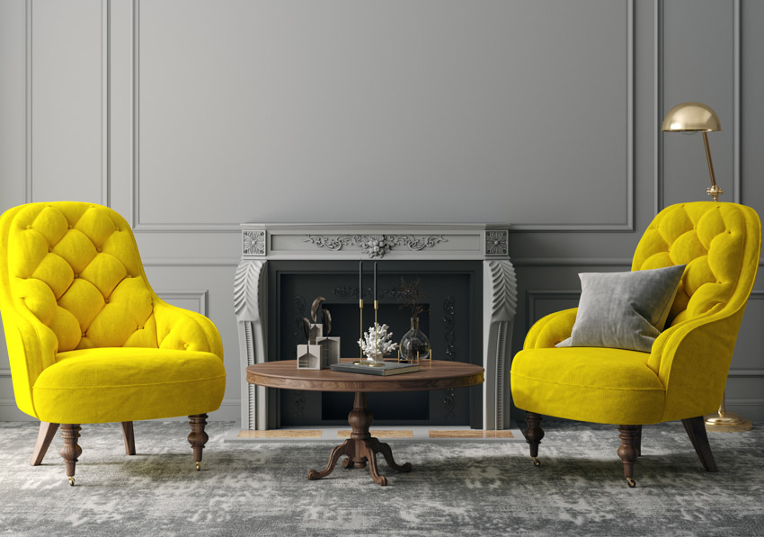 Gray wall yellow sofa chairs rug coffee table lamp is