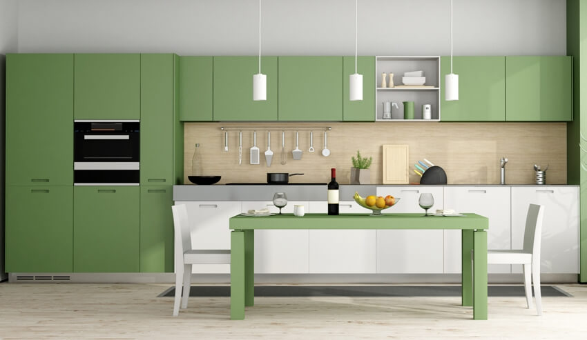 Green and white modern kitchen with dining table