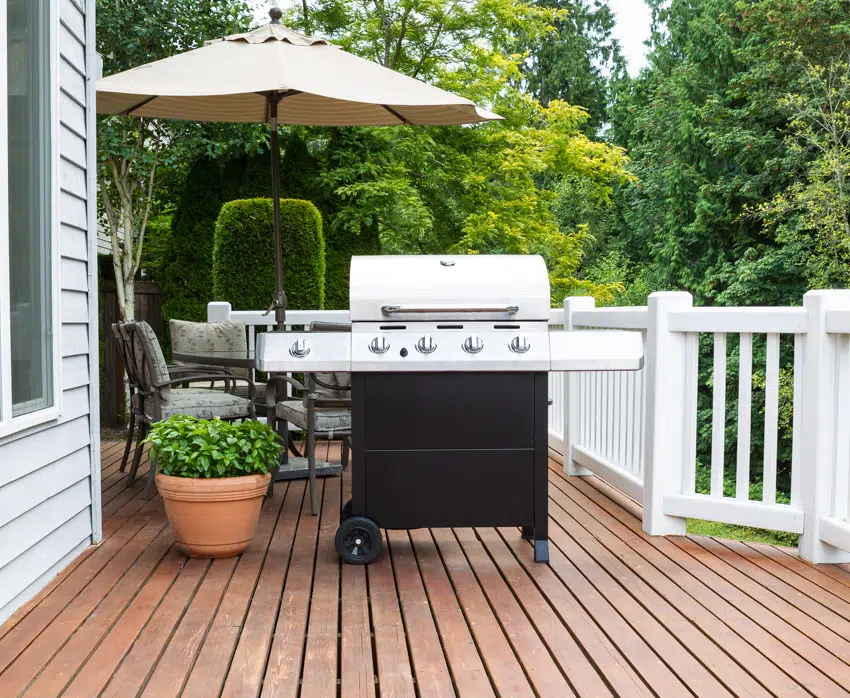 Grill outdoor wood deck white railings siding