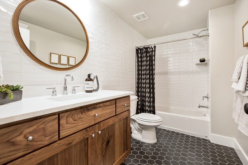 Hexagon patterned dark tile flooring in newly constructed bathroom