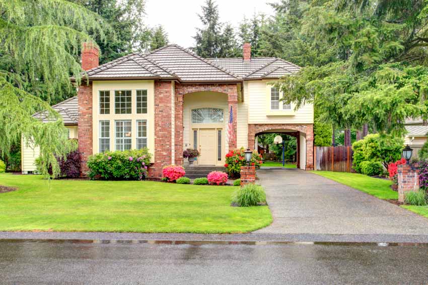 House exterior with masonry walls,concrete driveway glass windows front door