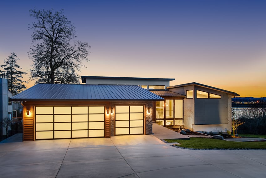 House exterior with metal roof garage driveway