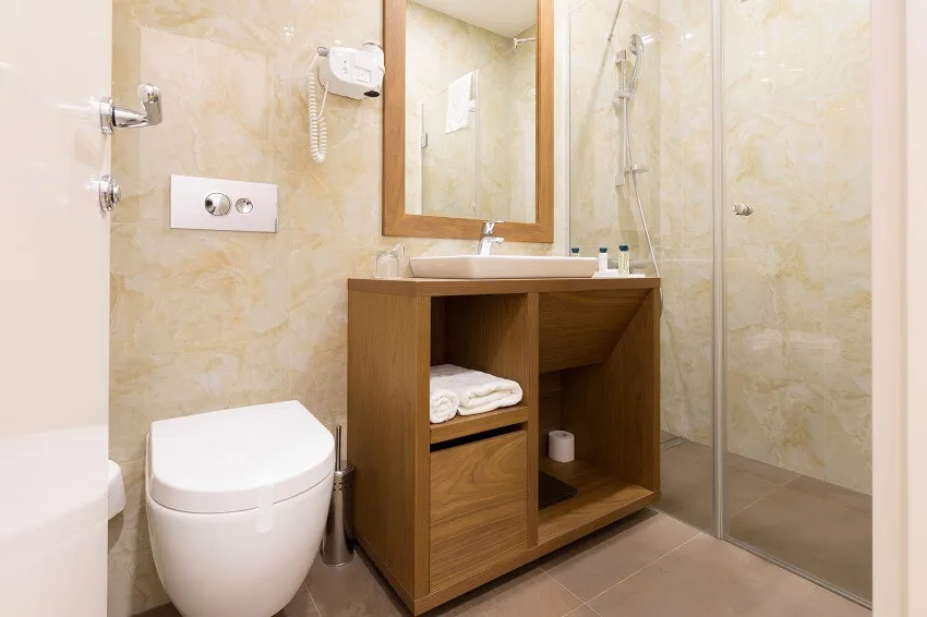 https://designingidea.com/wp-content/uploads/2021/10/interior-of-a-hotel-bathroom-with-toilet-and-shower-is.jpg.webp