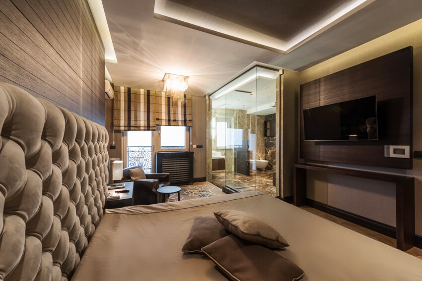 Interior of a master bedroom with luxury bathroom and furniture