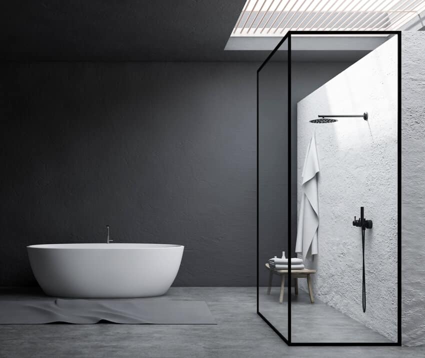 Interior of stylish bathroom with gray and white stucco shower walls concrete floor shower stall with glass walls white bathtub and table
