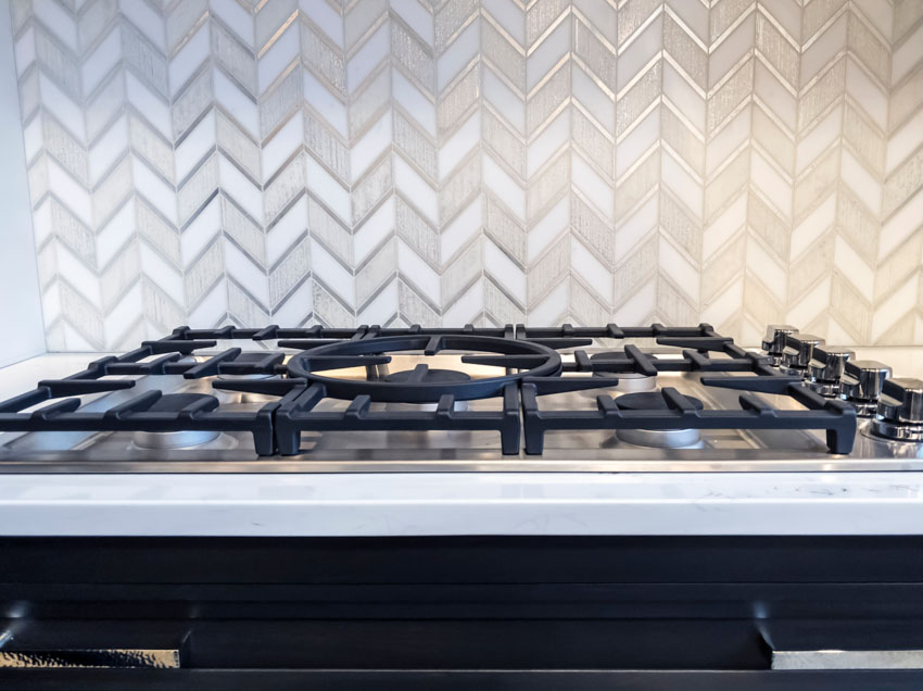 Kitchen with chevron design tile backsplash