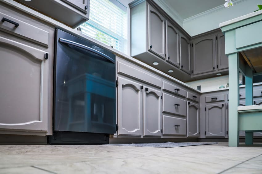 Kitchen with tile floors oven and gray cabinets with thermofoil