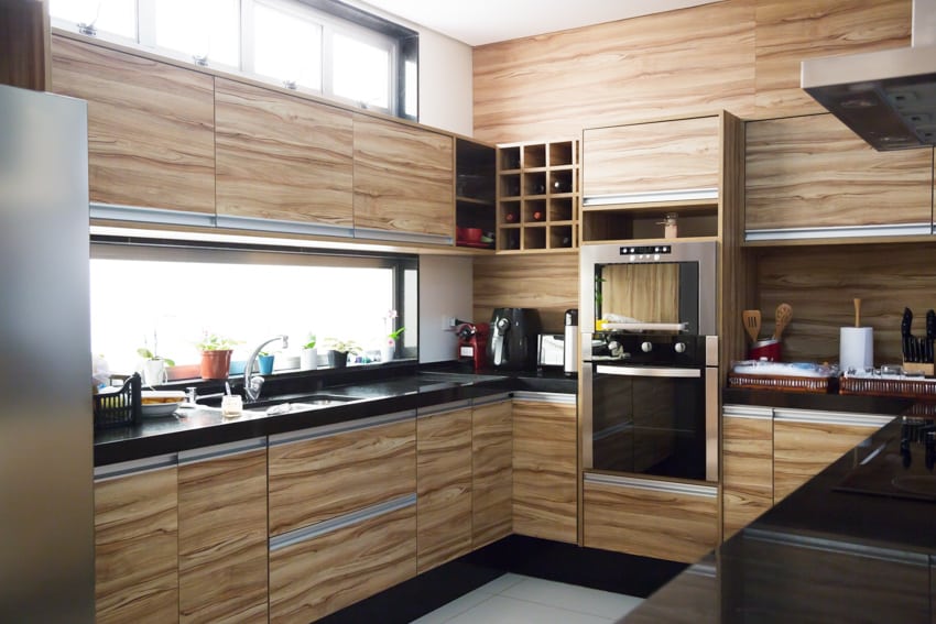 Kitchen with woodlike thermofoil cabinets oven window countertop