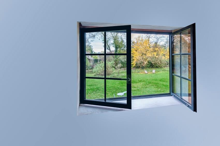 Large black aluminum open window with scenic nature view and copy space