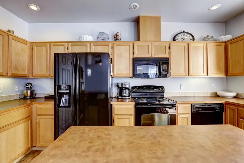 Light brown kitchen with black stainless steel appliances