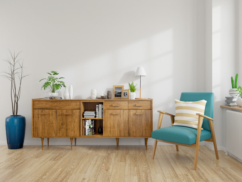 Light hardwood flooring teal chair small cabinet indoor plants