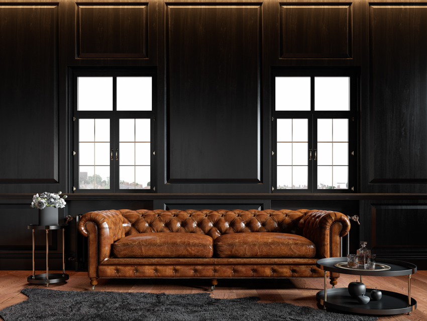 Living room brown leather couch black wall vinyl windows rug wood floor