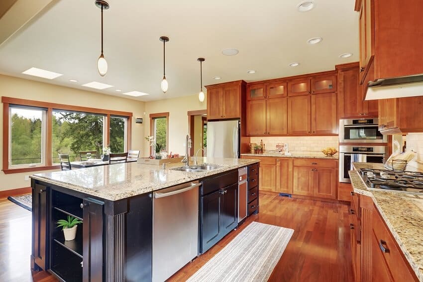 Luxury kitchen with bar style island maple cabinets and hardwood floor