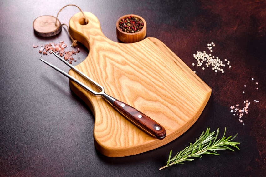 Maple wood Cutting board with salt spices and herbs on the side