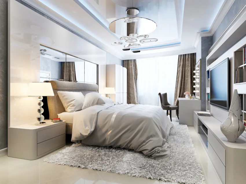 Mirror panels above bed and on the ceiling large window television bedroom
