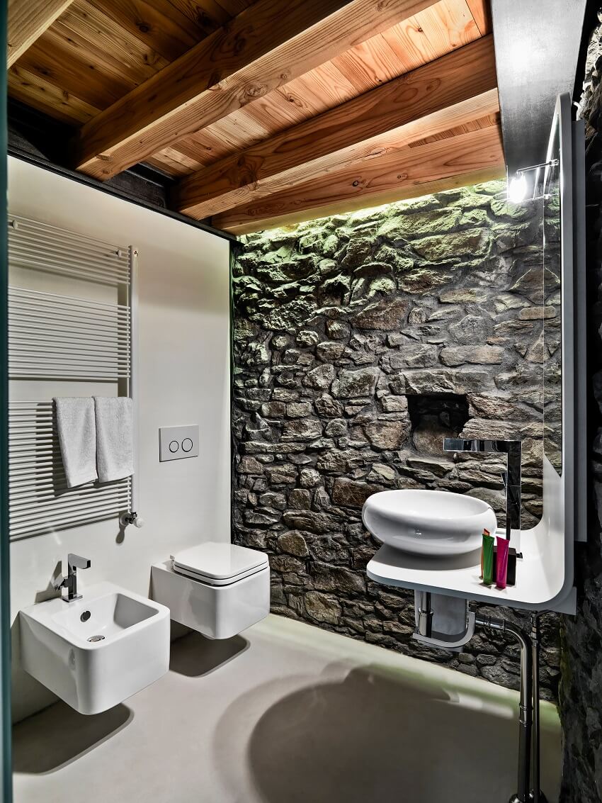 Modern style bathroom with stone wall, wooden ceiling and resin-made floor 