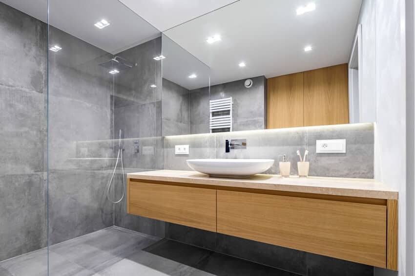 Modern bathroom with wooden countertop shower basin and big mirror