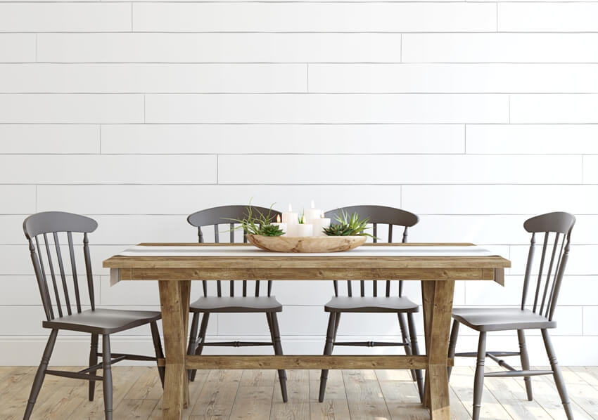 Modern farmhouse dining room with white shiplap wood panel wall and dining set