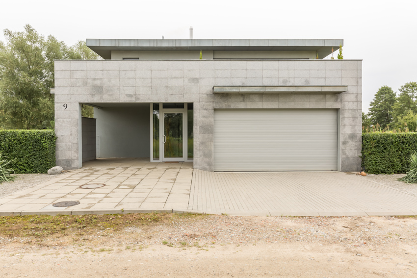 Modern house with concrete siding garage