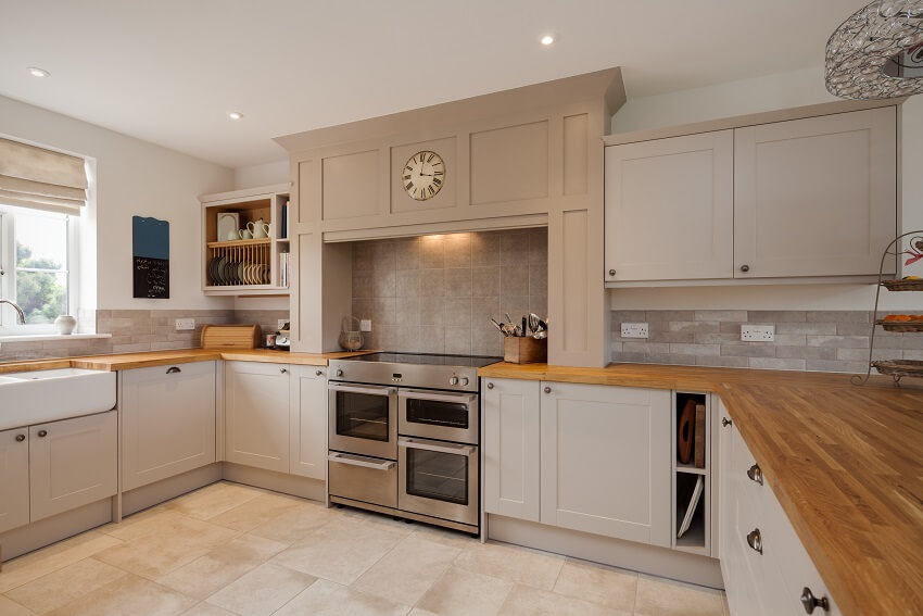 Modern kitchen interior with fitted appliances including oak strip countertops and worksurfaces cupboards and drawers