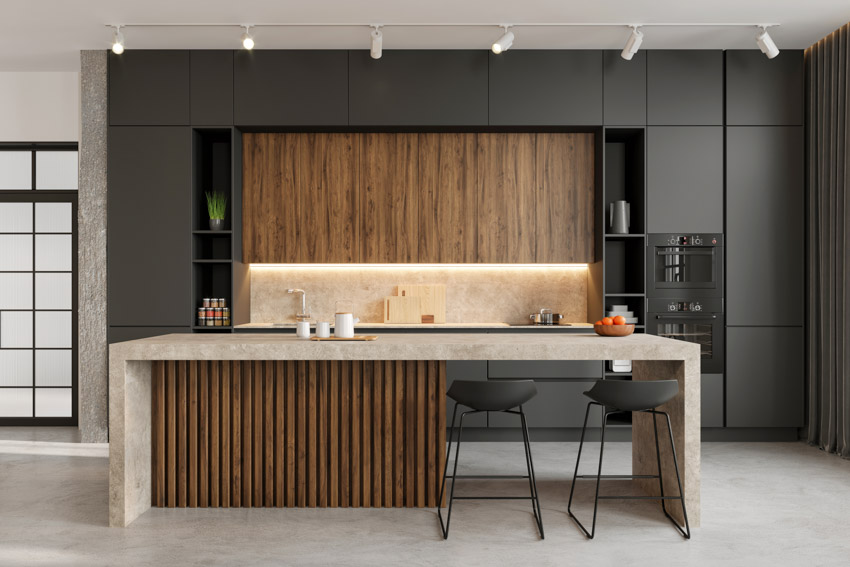 Modern kitchen with black cabinets lighting floating center island