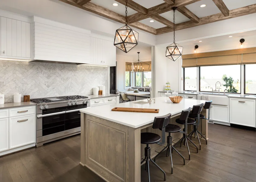 Modern kitchen with herringbone backsplash wood flooring center island hanging light hood oven glass windows