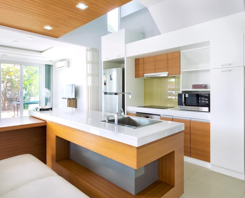 Modern kitchen home interior design with laminated wood cabinets and white countertops