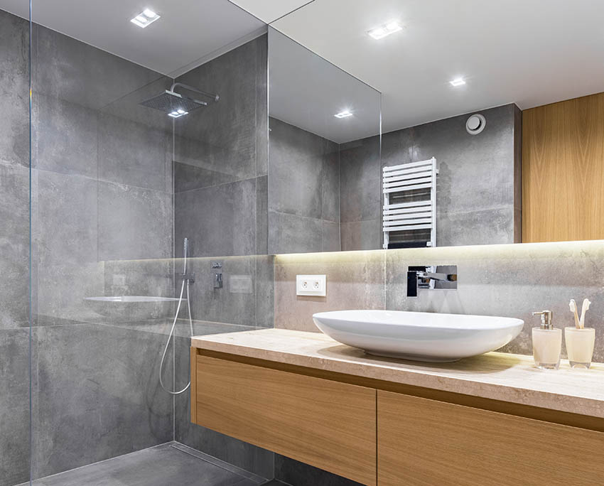 Modern look shower with gray tadelakt walls, rainfall head and floating vanity