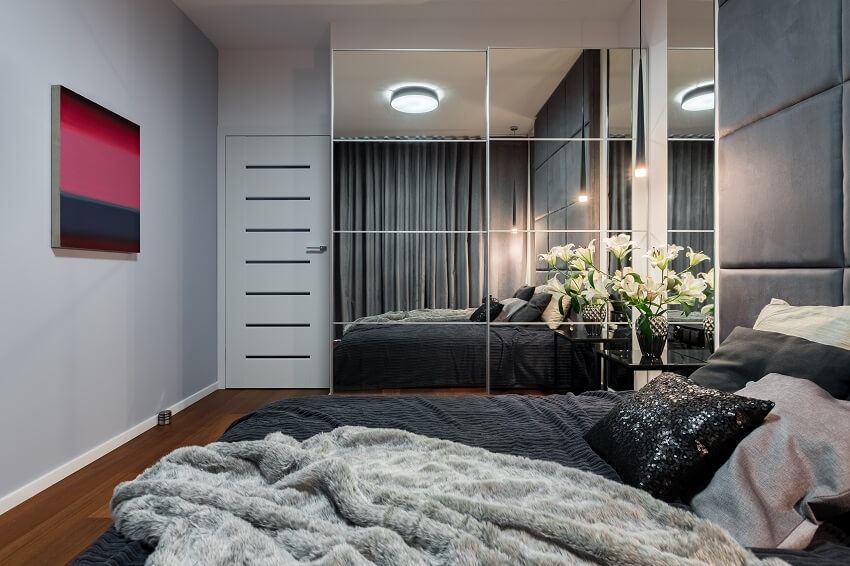 New design bedroom with bed mirrored wardrobe and modern painting
