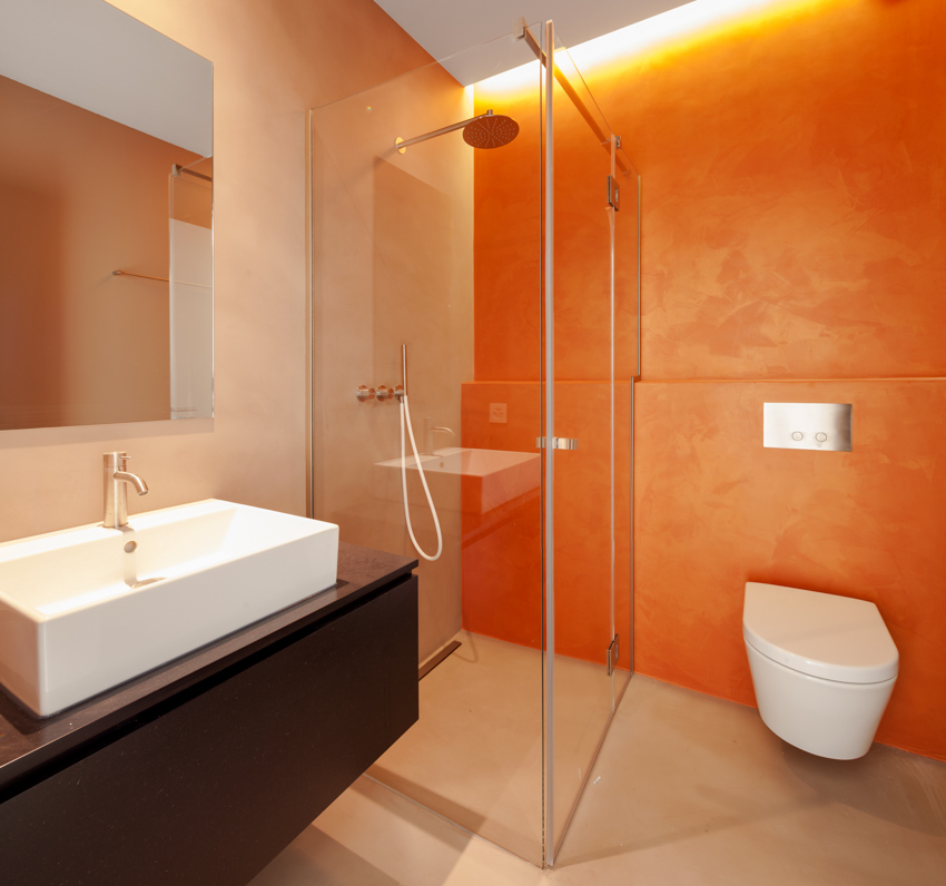 Orange tadelakt wall finish shower toilet sink mirror bathroom 