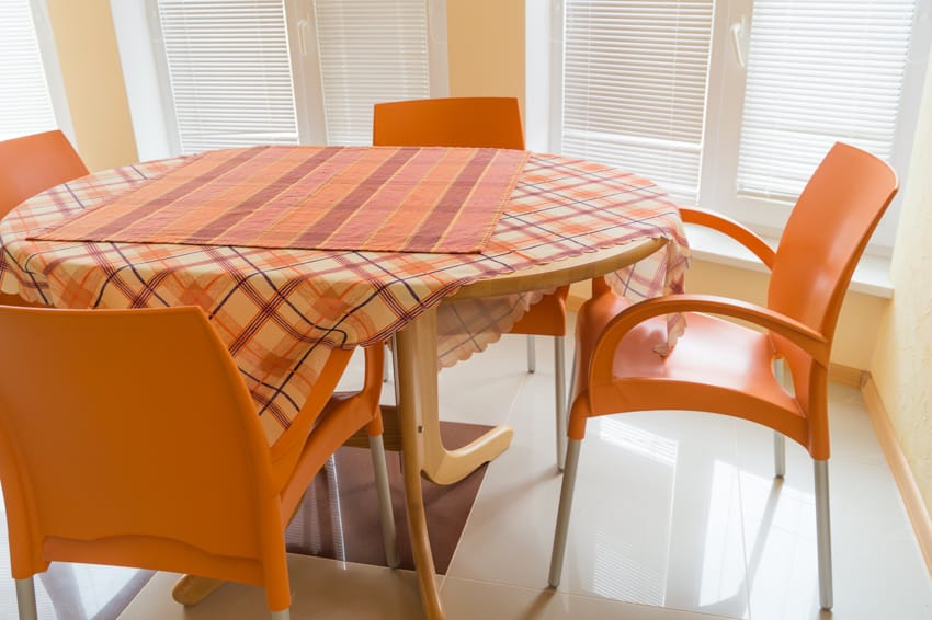 Oval table orange tablecloth chairs dining room