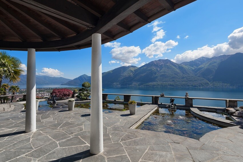 Porch of a beautiful terrace with ornamental garden lake view