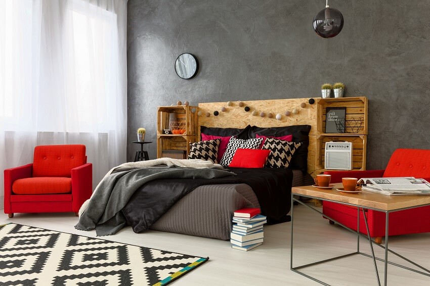 Red armchair in modern bedroom with concrete wall