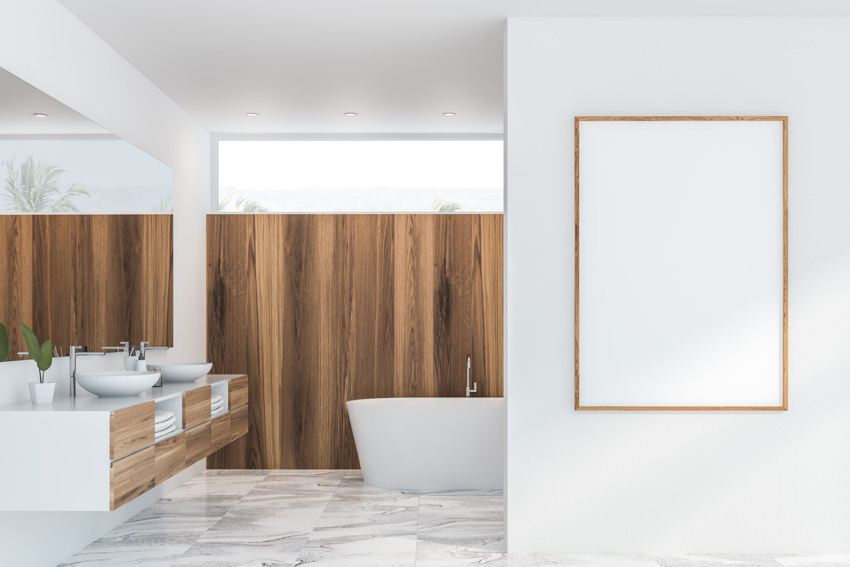 Spacious bathroom with porcelain tiles that look like marble mirror sink bathtub