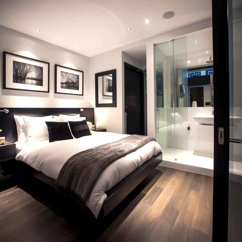 Spacious black and white bedroom with ensuite bath and toilet