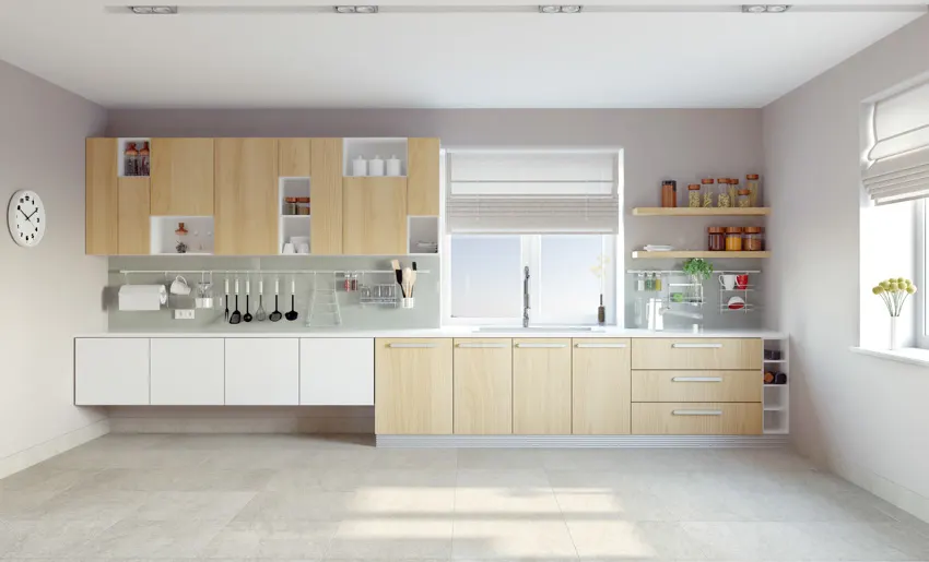 Spacious kitchen with light brown wood cabinets and drawers sink windows