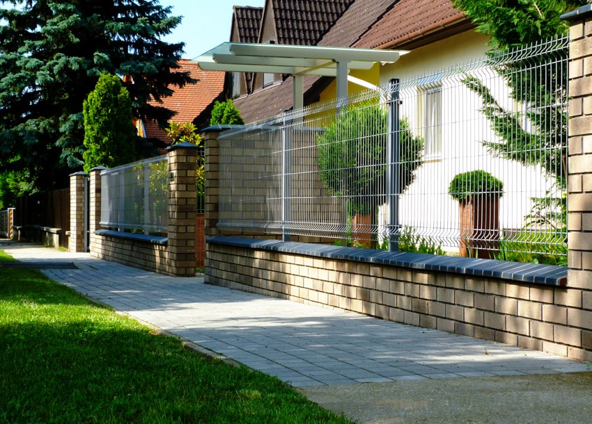 Welded wire fence surrounding residential property
